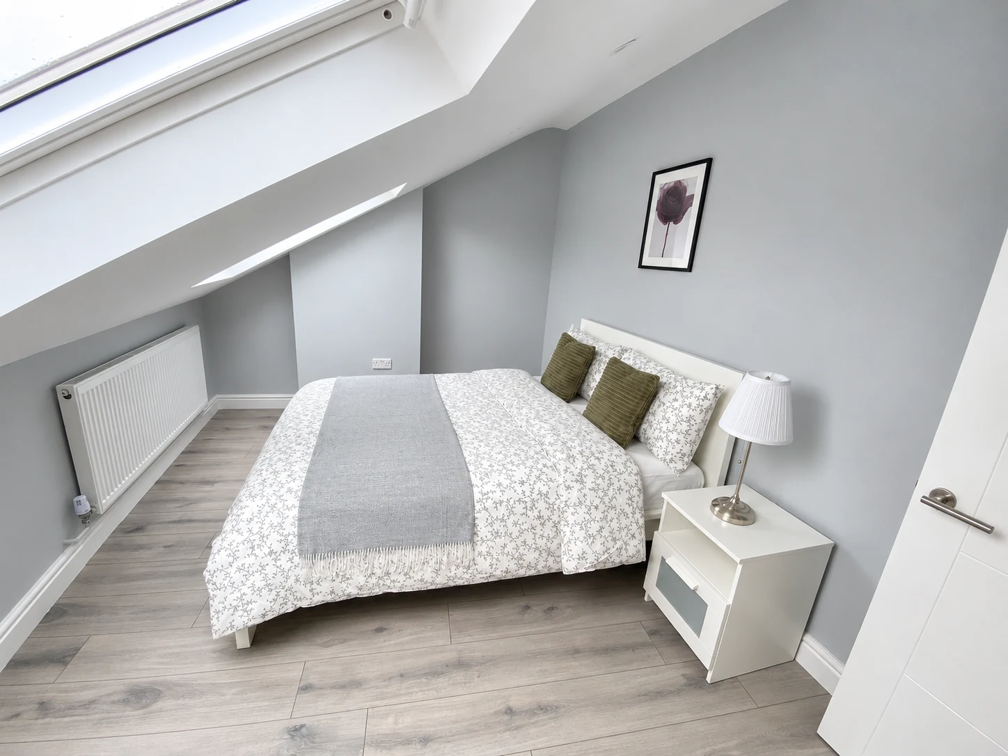 A prepared double bed beneath the skylight at North London Flat 4